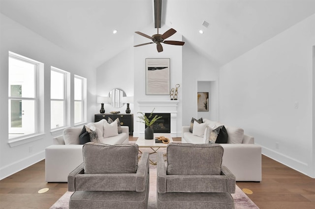 living room featuring beam ceiling, high vaulted ceiling, ceiling fan, and dark wood-type flooring