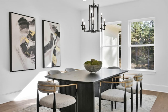 dining area with a chandelier and dark wood-type flooring