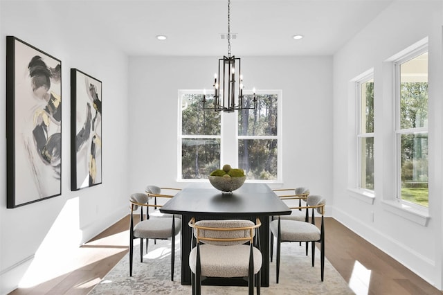 dining room with a chandelier and light hardwood / wood-style flooring