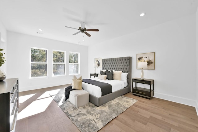 bedroom with light hardwood / wood-style floors and ceiling fan