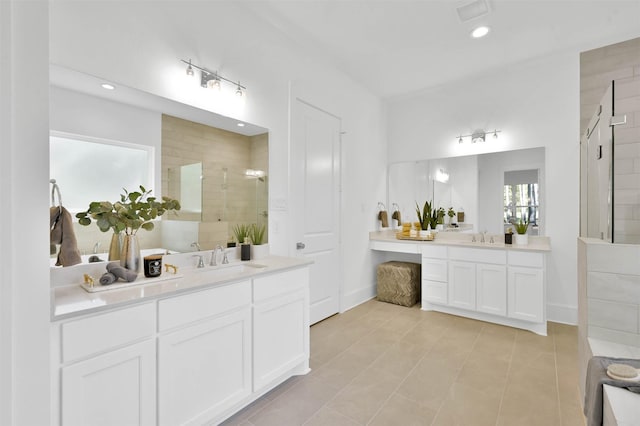 bathroom featuring vanity, tile patterned floors, and walk in shower