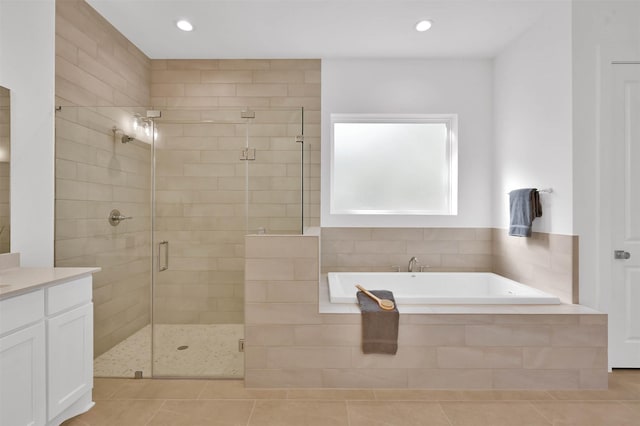 bathroom featuring tile patterned floors, plus walk in shower, and vanity