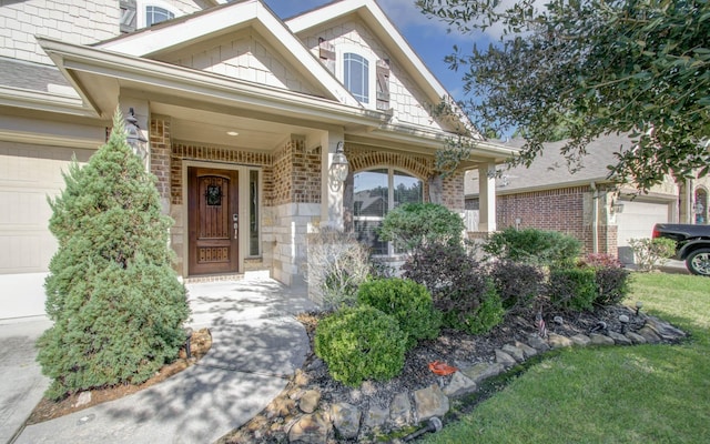 view of exterior entry featuring a porch and a garage