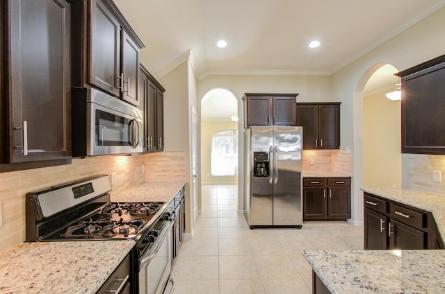 kitchen featuring decorative backsplash, ornamental molding, and appliances with stainless steel finishes