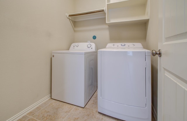 laundry area featuring washer and clothes dryer and light tile patterned floors