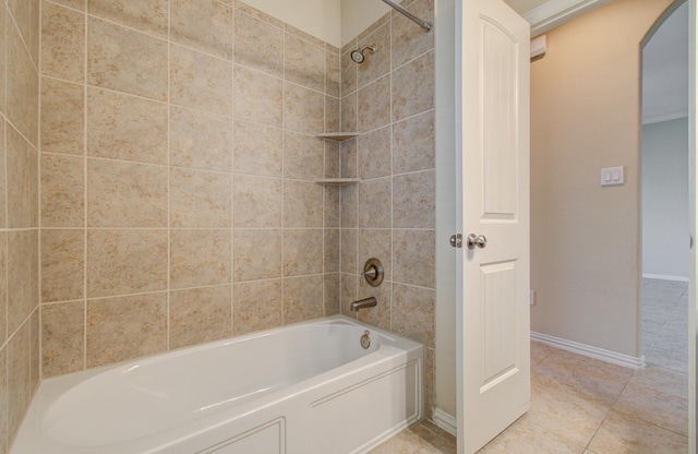 bathroom featuring tile patterned floors and tiled shower / bath