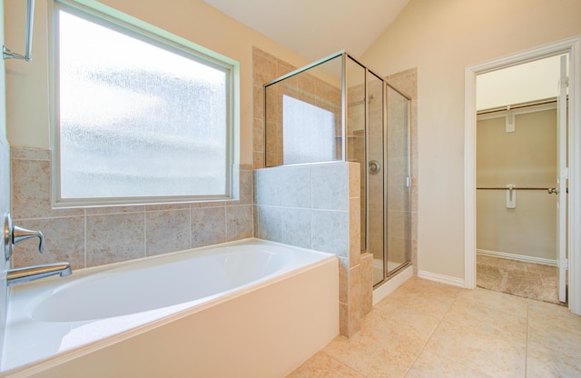 bathroom featuring shower with separate bathtub, tile patterned floors, and lofted ceiling