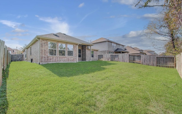 back of house with a yard