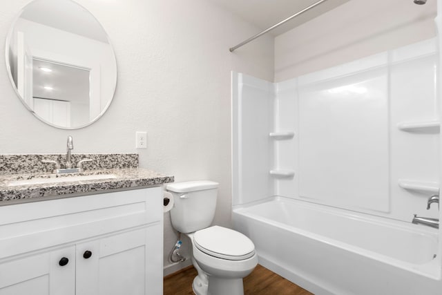 full bathroom with hardwood / wood-style floors, vanity, toilet, and shower / washtub combination