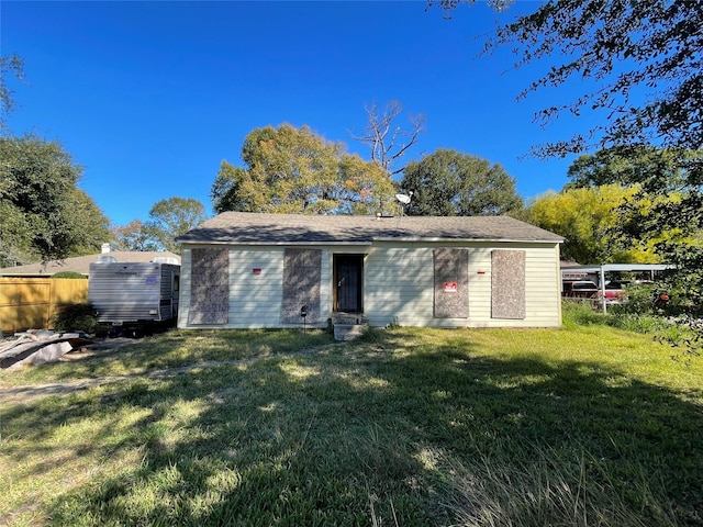 rear view of property with a yard