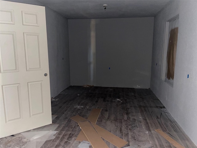 empty room with dark hardwood / wood-style flooring