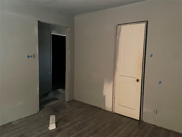 empty room with dark wood-type flooring