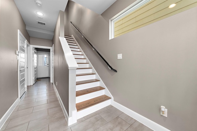 stairway featuring tile patterned flooring