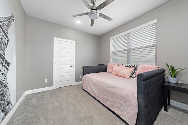 bedroom with ceiling fan and light carpet