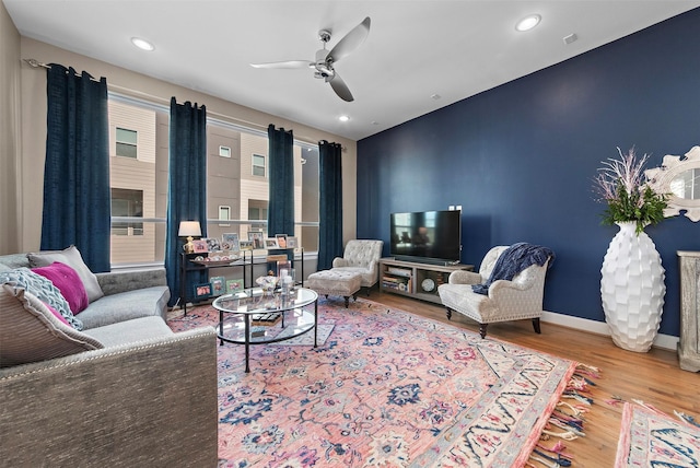 living room featuring ceiling fan and wood-type flooring