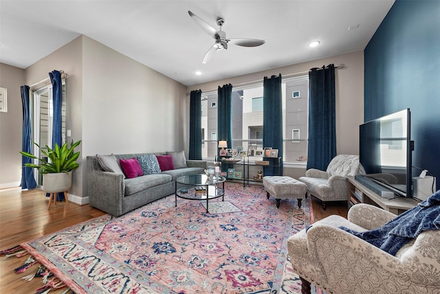 living room with hardwood / wood-style floors and ceiling fan