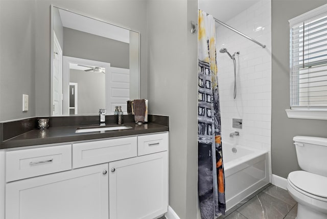 full bathroom with ceiling fan, vanity, shower / tub combo, and toilet