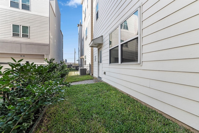 view of side of home with a yard