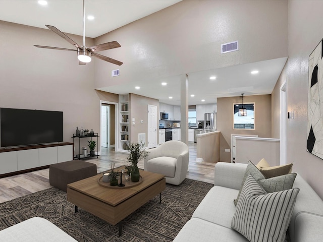 24 N Omega St, La Marque, TX 77568 - living room with ceiling fan, dark hardwood / wood-style flooring, and a high ceiling