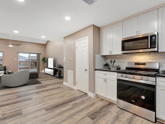 24 N Omega St, La Marque, TX 77568 - kitchen with tasteful backsplash, stainless steel appliances, ceiling fan, light hardwood / wood-style flooring, and white cabinetry