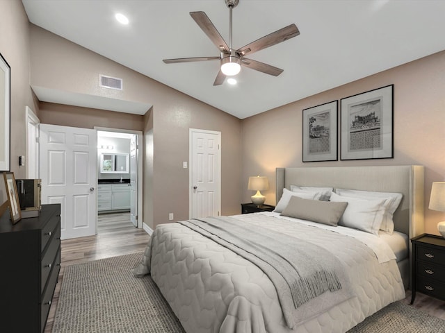 24 N Omega St, La Marque, TX 77568 - bedroom with dark hardwood / wood-style floors, ceiling fan, lofted ceiling, and ensuite bathroom