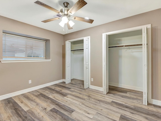 24 N Omega St, La Marque, TX 77568 - unfurnished bedroom featuring ceiling fan, two closets, and light hardwood / wood-style flooring