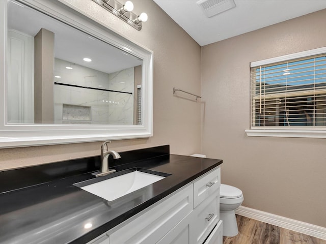 24 N Omega St, La Marque, TX 77568 - bathroom with toilet, hardwood / wood-style floors, vanity, and walk in shower