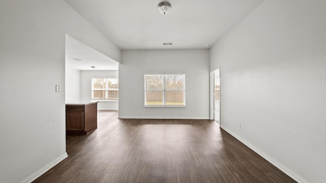 empty room with dark hardwood / wood-style floors