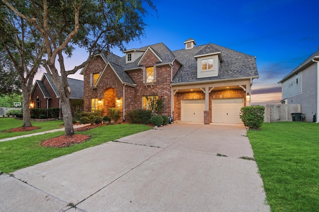 view of front facade featuring a garage and a yard