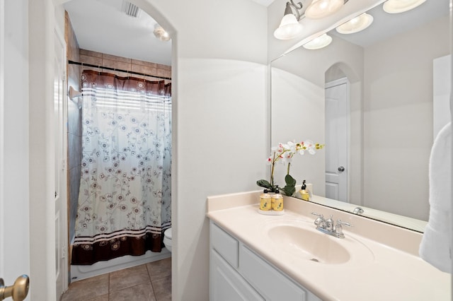 bathroom with tile patterned floors, vanity, toilet, and walk in shower