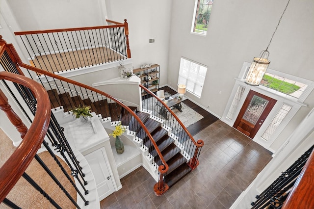 foyer with a towering ceiling and an inviting chandelier