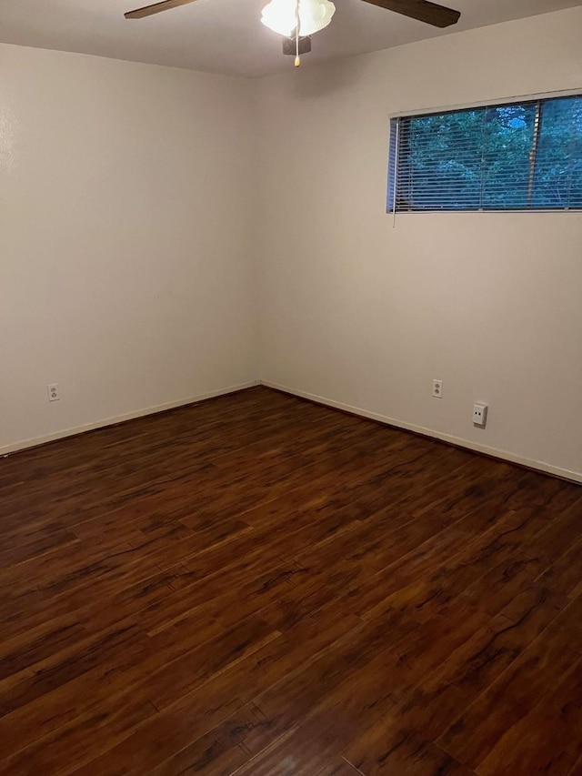 unfurnished room featuring ceiling fan and dark wood-type flooring