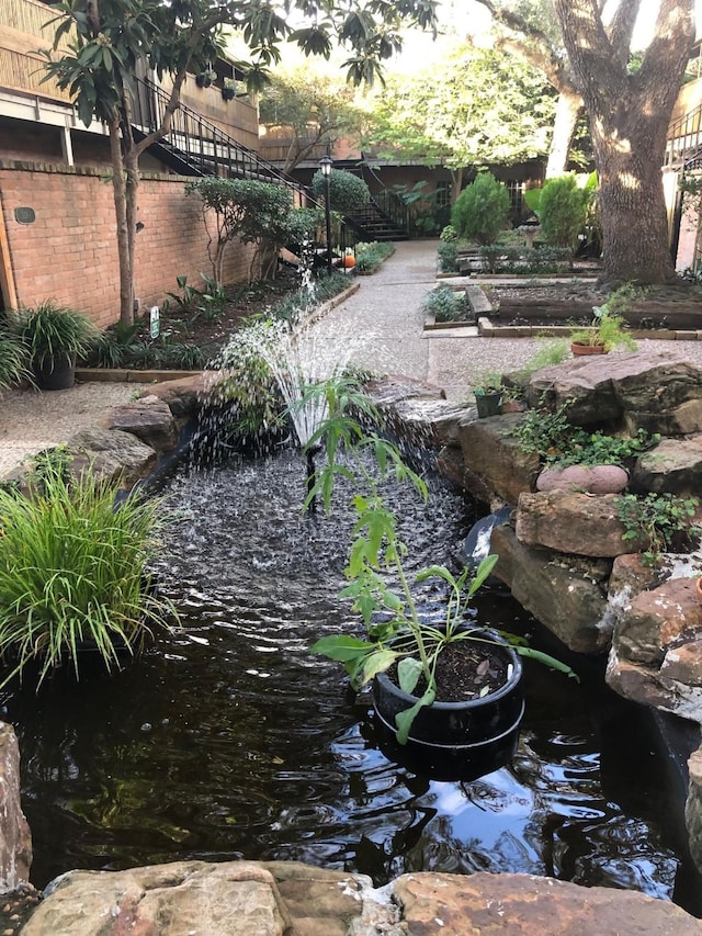 view of yard featuring a small pond