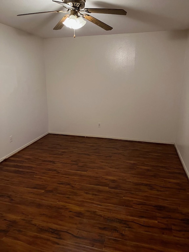 empty room featuring ceiling fan and dark wood-type flooring