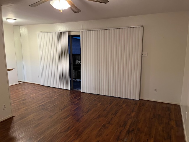 unfurnished room featuring dark hardwood / wood-style floors and ceiling fan