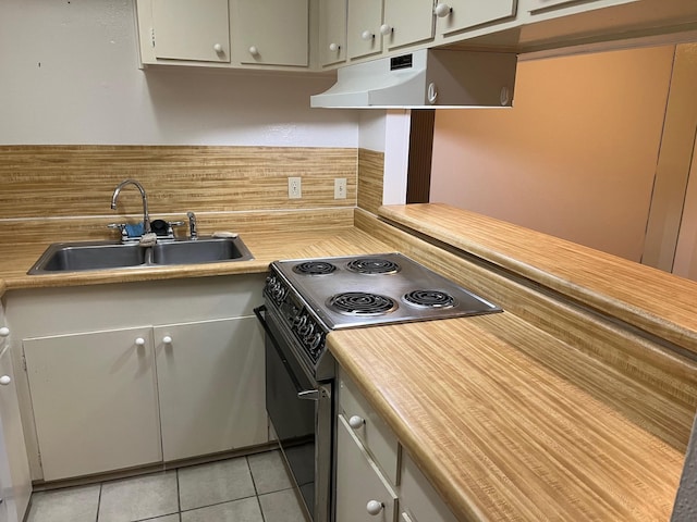 kitchen featuring tasteful backsplash, light tile patterned floors, sink, and black electric range