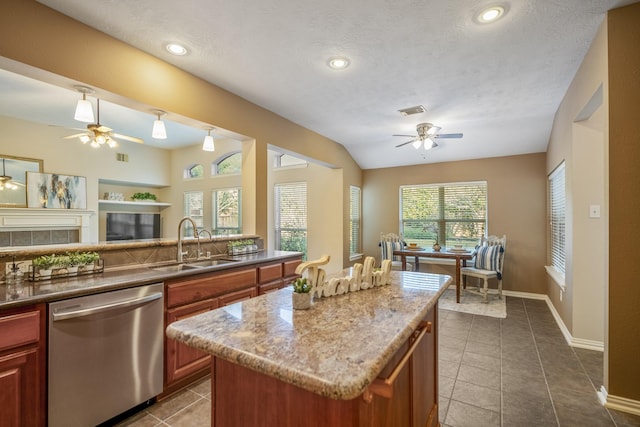 kitchen with a textured ceiling, sink, dishwasher, a center island, and lofted ceiling