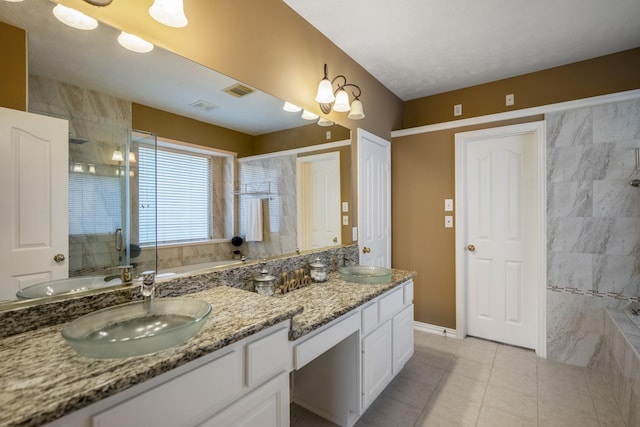 bathroom with plus walk in shower, vanity, and tile patterned floors