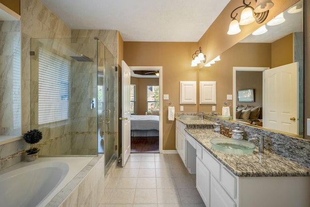 bathroom with tile patterned flooring, vanity, and plus walk in shower