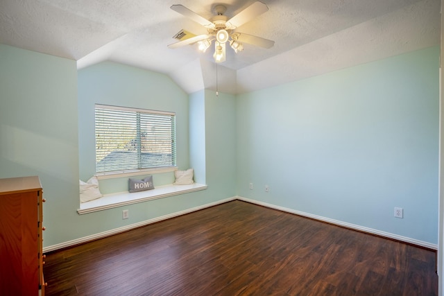 unfurnished room featuring a textured ceiling, ceiling fan, dark hardwood / wood-style flooring, and vaulted ceiling