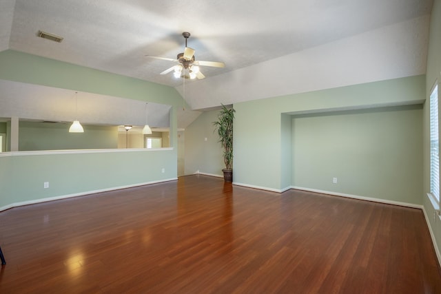 unfurnished living room featuring dark hardwood / wood-style floors, ceiling fan, lofted ceiling, and a textured ceiling