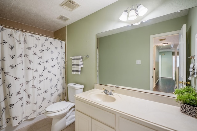 bathroom featuring toilet, a textured ceiling, vanity, and tile patterned floors