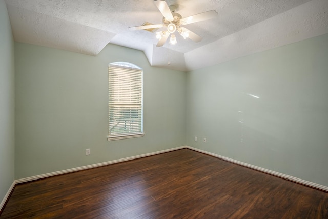 unfurnished room with a textured ceiling, ceiling fan, and dark wood-type flooring