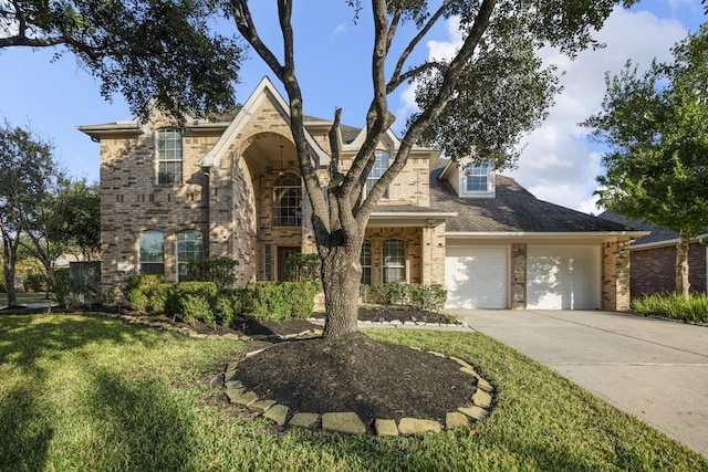 view of front of property featuring a front yard and a garage