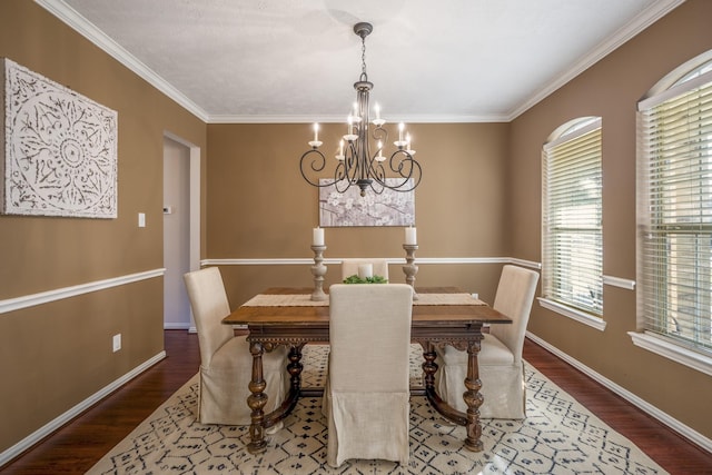 dining room with crown molding, wood-type flooring, and a notable chandelier