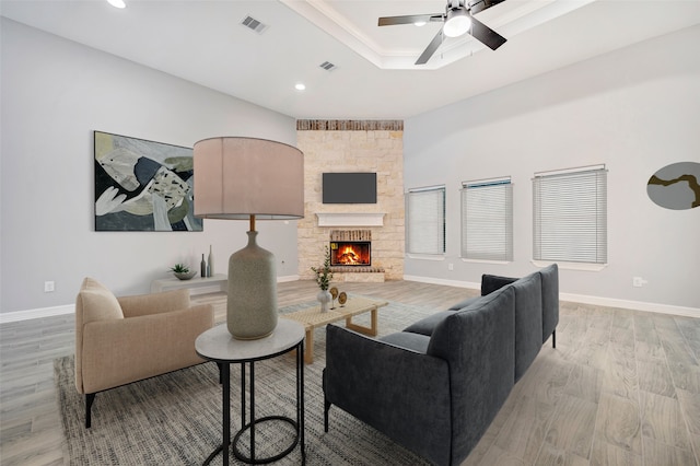 250 Broadmoor Dr, Huntsville, TX 77340 - living area featuring a tray ceiling, light wood-style flooring, visible vents, and a ceiling fan