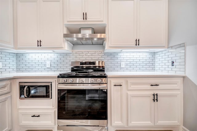 kitchen with white cabinets, backsplash, stainless steel appliances, and wall chimney exhaust hood