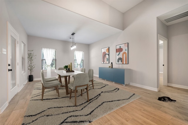 dining room featuring light hardwood / wood-style floors and an inviting chandelier