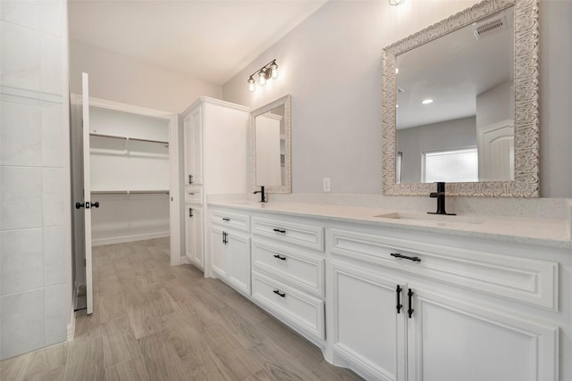 bathroom with vanity and hardwood / wood-style flooring