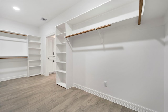 walk in closet with light wood-type flooring